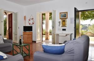 a living room with a blue couch and a table at Villa Bellevue in Santa Maria