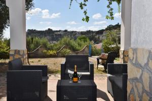 a bottle of wine sitting on a table on a patio at Villa Bellevue in Santa Maria