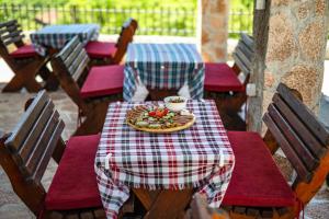 a table with a plate of food on top of it at Wild silence - Skadar Lake in Virpazar