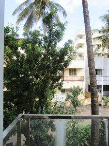 a view from the balcony of a hotel with palm trees at 1 BHK Bedroom Apartment ,Couple Friendly in Belgaum