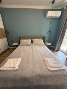 a large bed in a room with two tables at Chernomorets Apartment in Chernomorets