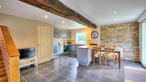 a kitchen with a table and a dining room at Relais Solognot in Sennely +17 photos