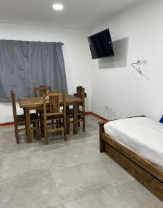 a bedroom with a table and chairs and a television at Junín departamento in Junín
