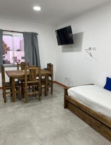 a bedroom with a bed and a table and a television at Junín departamento in Junín