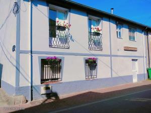 a white building with flower boxes on the windows at Casa Engracia in Arcos