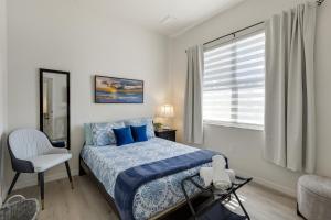 a bedroom with a bed and a chair and a window at Waterfront House in Paradise at Cape Coral in Cape Coral +38 photos