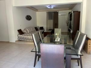 a dining room with a glass table and chairs at Angela House in Symi +7 photos