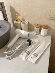 a white bathroom counter with a sink and toiletries at ЖК "Light House", 2 in Astana
