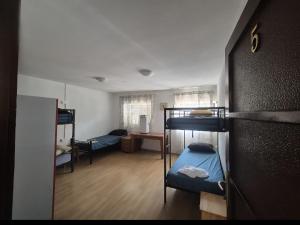 a room with three bunk beds and a desk at Hostel Hakuna Matata in Dubrovnik