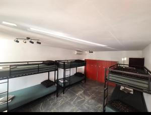 a room with four bunk beds and red walls at Hostel Hakuna Matata in Dubrovnik