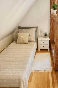 a bedroom with a large bed with a night stand at Dobré časy - Studio I. in Banská Štiavnica
