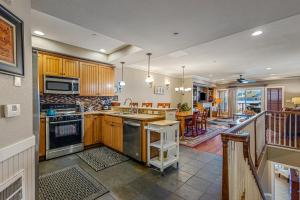 a kitchen with wooden cabinets and a counter top at CSC3S - Drive In in Kill Devil Hills