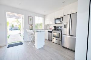 a kitchen with white cabinets and stainless steel appliances at Waterfront Cabana 5 Key Largo in Key Largo