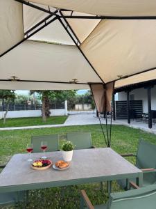 un tavolo con due piatti di bicchieri da cibo e da vino di Gold Coast Luxury Studio a Paralia Neas Triglias