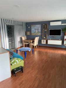 a living room with a couch and a table at Ilonas Home in Baden-Baden