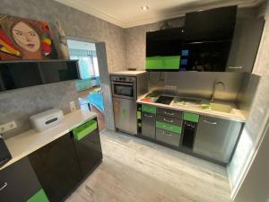 a kitchen with green and black cabinets in a room at Ilonas Home in Baden-Baden