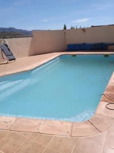 a large blue swimming pool on a patio at Cortijo Estrella in Serón