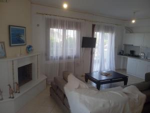 a living room with a couch and a table at Sweet Home in Platamonas