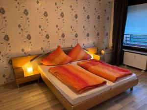 a bed with colorful pillows on it in a room at Ferienwohnung -Schöne Aussicht- im Taunusblick A-1003 in Lahnstein +24 photos