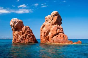 two rocks in the water on a beach at Mediterranean Whisper in Santa Maria Navarrese +27 photos
