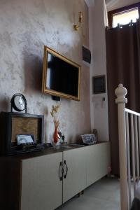 a living room with a television on a wall at Riverside Apartment in Bitola +40 photos