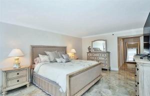 a bedroom with a large bed and two night stands at Renovated Oceanfront Condo with Intracoastal Views in Hollywood