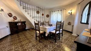 a dining room with a white table and chairs at Elisabeth's Tower House in Denia
