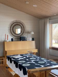 a room with a table and a mirror on the wall at Rytkynranta Village 