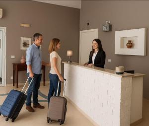 a group of people standing at a counter with luggage at SOGNO D'ESTATE 2 in Mazara del Vallo