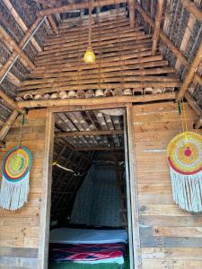 an inside of a wooden building with baskets on the ceiling at Bamboo hutz in Jāmb
