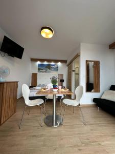 a living room with a table and two chairs at Holiday Amber - in Niechorze