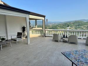 a patio with chairs and tables on a balcony at La Terrazza di Finuzzu in Rende