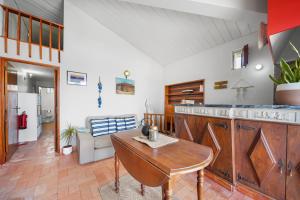 a kitchen with wooden cabinets and a wooden table at Sea Hut Apulia in Apúlia +13 photos