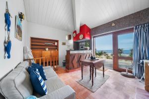 a living room with a couch and a table at Sea Hut Apulia in Apúlia