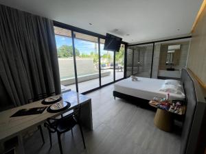 a hotel room with a bed and a table and a desk at Motel UP (Adult Only) in Fortaleza +62 photos