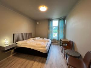 a bedroom with a bed and a table and chairs at Åndalsnes house in Åndalsnes