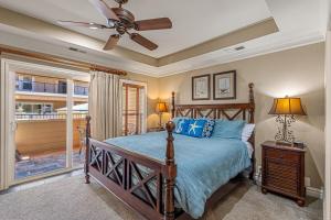 a bedroom with a bed and a ceiling fan at CSC3S - Drive In in Kill Devil Hills +50 photos