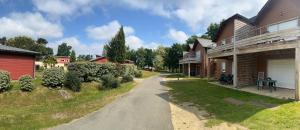 a house with a driveway leading into a yard at Chez Caro in Chaveignes