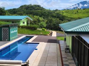 a house with a swimming pool next to a building at 2 Bedroom Guest House with Pool in Hacienda Miravalles