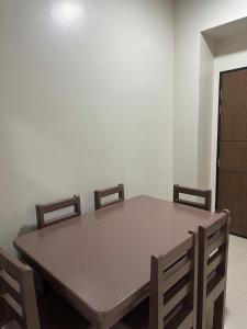 a dining room table and chairs in a room at Cozy Condo in Megaworld Iloilo in Iloilo City +6 photos