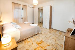 a bedroom with a bed and a stone floor at Casa Donna Celestina in Letojanni