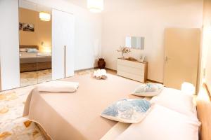 a large room with two beds and a bedroom at Casa Donna Celestina in Letojanni