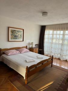 a bedroom with a large bed with two pillows at obzor, orkinos in Obzor