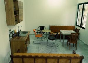 a kitchen with a table and chairs in a room at Morina Rooms in Durrës +16 photos