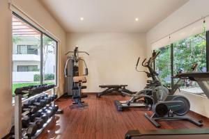 a gym with treadmills and ellipticals in a room at RayoDeSol Condo10min to Beach,Gym,Pool,WIFI 200MB in Playa del Carmen