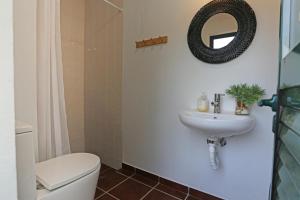 a bathroom with a sink and a toilet and a mirror at Tapada da Figueira by NaturAlegre in Esperança +20 photos