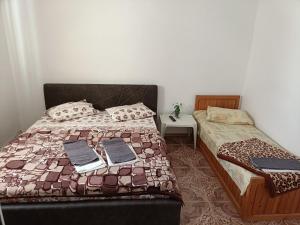 a bedroom with a bed with two books on it at Vila Andra in Costinesti +35 photos