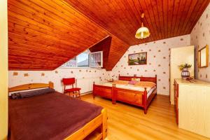 a bedroom with two beds and a wooden ceiling at Apartment in Keszthely - Balaton 18986 in Keszthely