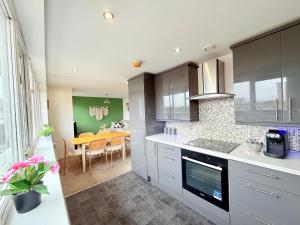 a kitchen with a table and a dining room at Penthouse with City Views in Bristol