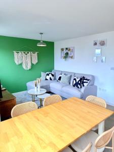 a living room with a table and a couch at Penthouse with City Views in Bristol